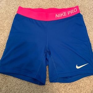 Blue Nike Pros with pink waist band